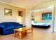 Living area/separate bedroom  - at Boathaven Bay Holiday Apartments
