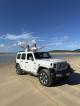 Couple with hands in air from car - 4WD Beach Adventure Sunny Jeeps
